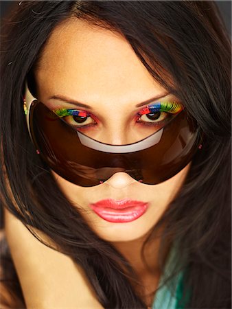 peeping fashion - Young woman peeking over sunglasses with fake eyelashes Stock Photo - Premium Royalty-Free, Code: 649-07904916