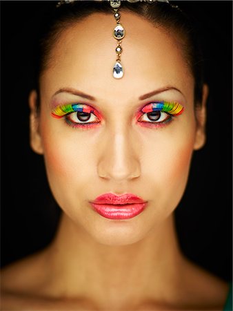 Young woman with jewel head accessory and coloured eyelashes Stock Photo - Premium Royalty-Free, Code: 649-07904917