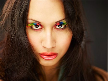 simsearch:614-01088532,k - Young woman wearing rainbow coloured fake eyelashes Photographie de stock - Premium Libres de Droits, Code: 649-07904913