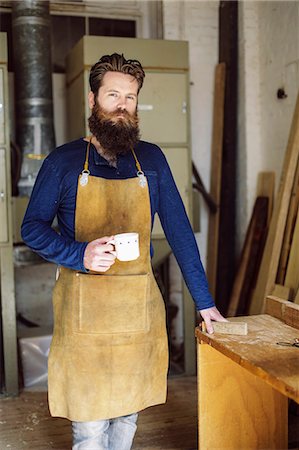 satisfied (thirst) - Portrait of mid adult craftsman drinking coffee in organ workshop Stock Photo - Premium Royalty-Free, Code: 649-07905023