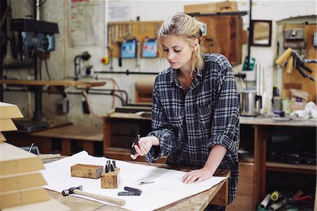 simsearch:649-07905035,k - Young craftswoman checking components on workbench in pipe organ workshop Stock Photo - Premium Royalty-Free, Code: 649-07905031