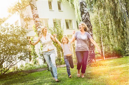 Girl being swung by mother and grandmother Stock Photo - Premium Royalty-Free, Code: 649-07905151