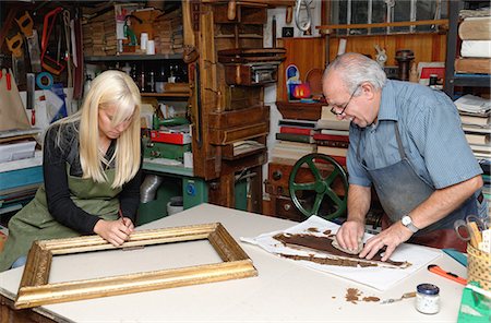 simsearch:649-07905311,k - Senior man and young woman restoring picture frame and book spine in traditional bookbinding workshop Stock Photo - Premium Royalty-Free, Code: 649-07905317