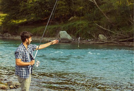 fish on fishing rods - Young man catching fish in river, Premosello, Verbania, Piemonte, Italy Stock Photo - Premium Royalty-Free, Code: 649-07905335