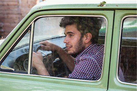 Young male farmer looking out of car window, Premosello, Verbania, Piemonte, Italy Stock Photo - Premium Royalty-Free, Code: 649-07905330