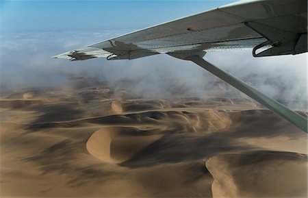 desert environmental concerns - Aerial view of airplane wing over dunes, Namib Desert, Namibia Stock Photo - Premium Royalty-Free, Code: 649-07905397