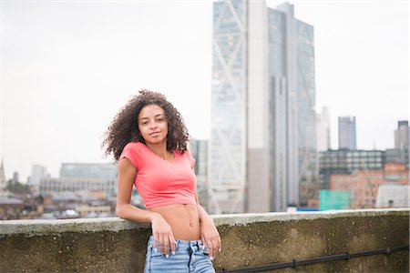 skyscraper rooftop - Young woman leaning against wall Stock Photo - Premium Royalty-Free, Code: 649-07905459