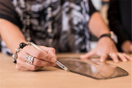 simsearch:649-07905510,k - Close up of mature seamstress drawing with curved ruler on dressmakers pattern in workshop Stock Photo - Premium Royalty-Free, Code: 649-07905496