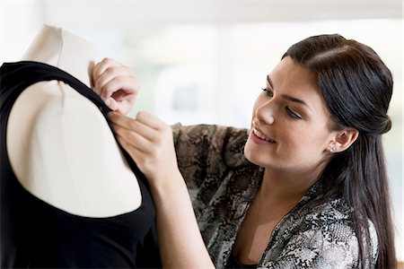 simsearch:649-07905510,k - Young seamstress pinning dress on tailors dummy in workshop Stock Photo - Premium Royalty-Free, Code: 649-07905515