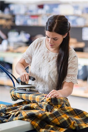 simsearch:649-07905510,k - Young seamstress ironing tartan jacket in workshop Stock Photo - Premium Royalty-Free, Code: 649-07905524