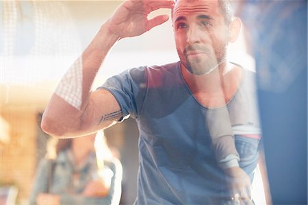 shopping window - Mid adult man looking in shop window Stock Photo - Premium Royalty-Free, Code: 649-07905641