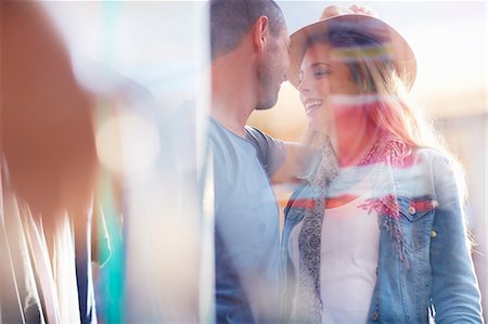Young couple standing face to face, seen through window Stock Photo - Premium Royalty-Free, Code: 649-07905643