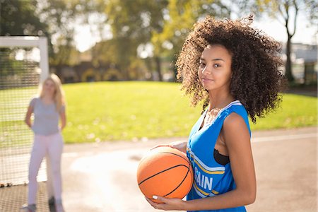 Portrait of young woman holding basketball Stock Photo - Premium Royalty-Free, Code: 649-07905652