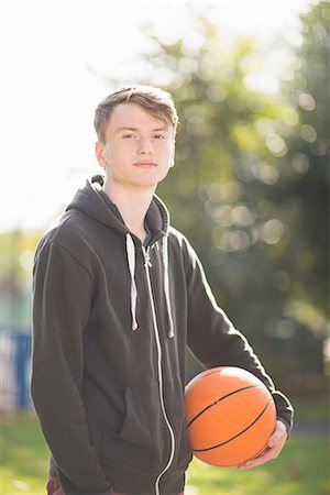 Portrait of young man holding basketball Stock Photo - Premium Royalty-Free, Code: 649-07905665