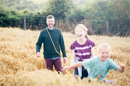 simsearch:649-07648152,k - Father with two girls running through field Stock Photo - Premium Royalty-Free, Code: 649-07905767
