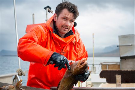 portraits of fishermen - Fisherman gutting fish Stock Photo - Premium Royalty-Free, Code: 649-08004134