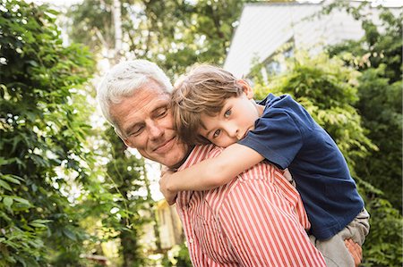 piggyback her boy - Grandfather carrying grandson on back Stock Photo - Premium Royalty-Free, Code: 649-08004195