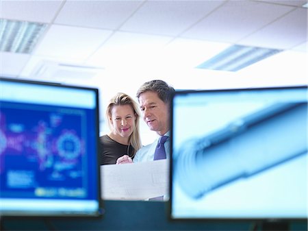 Female and  male engineer designers discussing plans in office Stock Photo - Premium Royalty-Free, Code: 649-08004239
