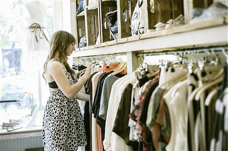 Mid adult woman searching clothes rail in vintage boutique Stock Photo - Premium Royalty-Free, Code: 649-08004288