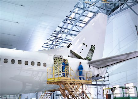 precision engineering - Engineers working on aircraft in aircraft maintenance factory Stock Photo - Premium Royalty-Free, Code: 649-08060102