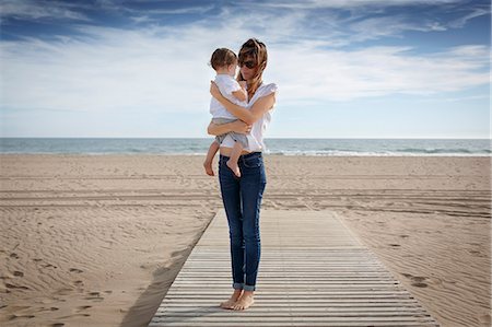 Mid adult woman and toddler daughter on beach, Castelldefels, Catalonia, Spain Foto de stock - Sin royalties Premium, Código: 649-08060187