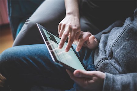 person touch screen - Couple using digital tablet, focus on hands Stock Photo - Premium Royalty-Free, Code: 649-08060286