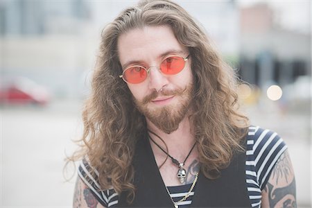 simsearch:649-08060336,k - Portrait of young male hippy with orange sunglasses and long hair Stock Photo - Premium Royalty-Free, Code: 649-08060319
