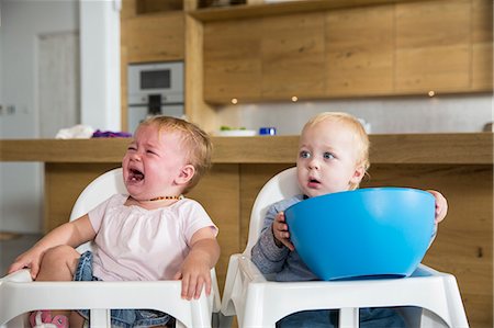 sad crying boy and girl images - Male and female twin toddlers in high chairs Stock Photo - Premium Royalty-Free, Code: 649-08060398