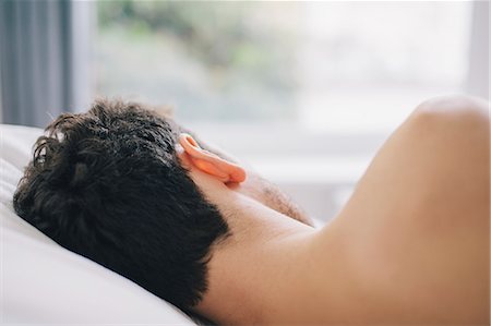 Close up rear view of young man asleep on pillow Stock Photo - Premium Royalty-Free, Code: 649-08060603