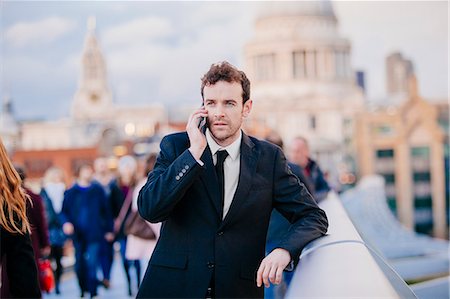 simsearch:649-07560135,k - Businessman chatting on smartphone whilst leaning on millennium bridge, London, UK Stock Photo - Premium Royalty-Free, Code: 649-08060613