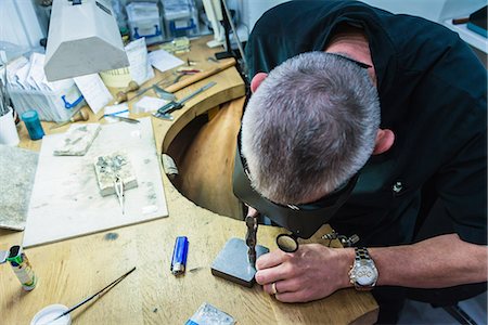 Jewellery craftsman using hammer on workbench Foto de stock - Sin royalties Premium, Código: 649-08060757