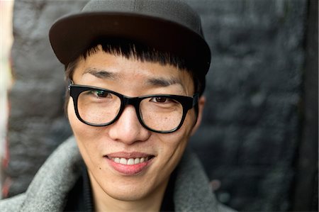 Portrait of bespectacled young man with cap Stock Photo - Premium Royalty-Free, Code: 649-08084534