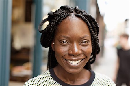 Portrait of young woman with plaited hairstyle Photographie de stock - Premium Libres de Droits, Code: 649-08084533