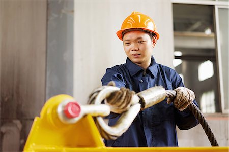 simsearch:649-07064833,k - Worker using equipment in crane manufacturing facility, China Stock Photo - Premium Royalty-Free, Code: 649-08084602