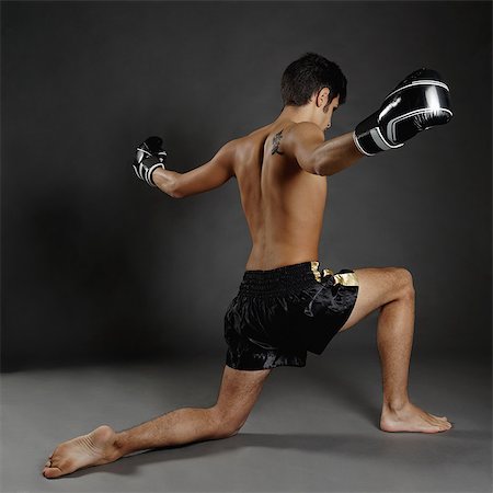 simsearch:649-07737114,k - Rear view of young man in boxing gloves poised on one knee Stockbilder - Premium RF Lizenzfrei, Bildnummer: 649-08084638