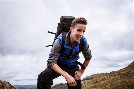 Young male hiker reaching top of mountain, The Lake District, Cumbria, UK Stock Photo - Premium Royalty-Free, Code: 649-08084704