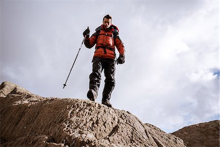 simsearch:649-07437610,k - Low angle view of young male hiker on rocks, The Lake District, Cumbria, UK Photographie de stock - Premium Libres de Droits, Code: 649-08084717