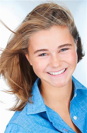 preteen girl 13 or 14 age - Portrait of smiling teenage girl with hair blowing Stock Photo - Premium Royalty-Free, Code: 649-08084727