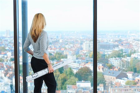 elevated view of a confident businesswoman - Mature female architect looking from office window at Brussels cityscape, Belgium Stock Photo - Premium Royalty-Free, Code: 649-08084756