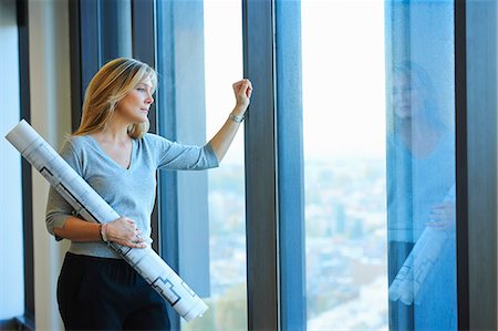 Portrait of mature female architect with plans in skyscraper office, Brussels, Belgium Stock Photo - Premium Royalty-Free, Code: 649-08084757