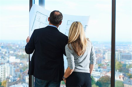 Male and female architects in front of office window with Brussels cityscape, Belgium Stock Photo - Premium Royalty-Free, Code: 649-08084752