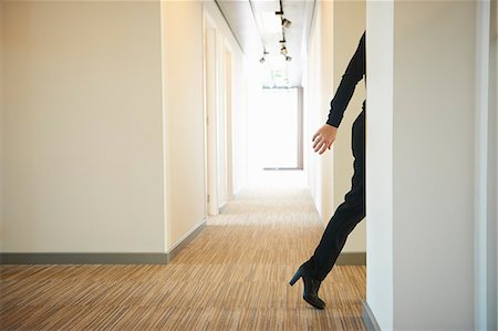 Woman walking across corridor Stock Photo - Premium Royalty-Free, Code: 649-08084766