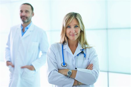 doctor and couple - Doctors posing against backlit wall panel Stock Photo - Premium Royalty-Free, Code: 649-08084777