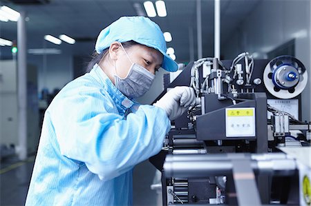 factory workers uniform - Worker at e-cigarettes battery factory, Guangdong, China Stock Photo - Premium Royalty-Free, Code: 649-08084819