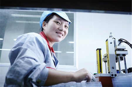 factory workers uniform - Worker at e-cigarettes battery factory, Guangdong, China Stock Photo - Premium Royalty-Free, Code: 649-08084826