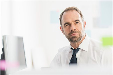 portrait, frontal - Businessman contemplating ideas in office Stock Photo - Premium Royalty-Free, Code: 649-08084880