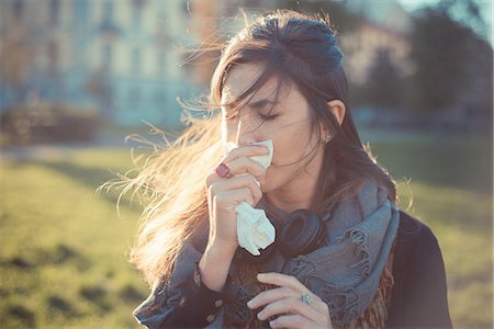 simsearch:649-08084934,k - Mid adult woman blowing nose with handkerchief in park Foto de stock - Sin royalties Premium, Código: 649-08084934