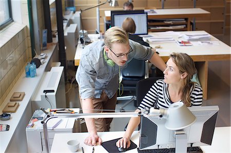 small business office collaboration - Colleagues sharing informal meeting at office desk Stock Photo - Premium Royalty-Free, Code: 649-08084978