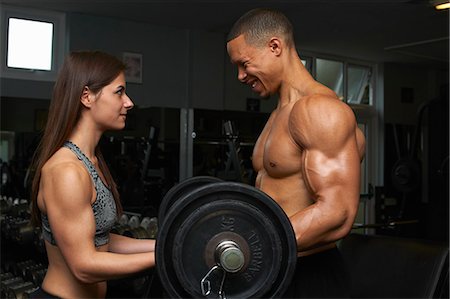 Young woman and mid adult man, lifting weights Stock Photo - Premium Royalty-Free, Code: 649-08085019