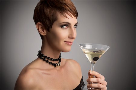 simsearch:649-09207442,k - Studio portrait of woman looking sideways holding cocktail Stock Photo - Premium Royalty-Free, Code: 649-08085090